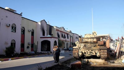 Members of Libyan forces loyal to the UN-backed government stand at Al Hadba prison that was damaged during heavy clashes with rival factions. Hani Amara / Reuters