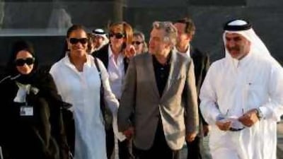 The US actor Robert De Niro and his wife Grace Hightower arrive at the Museum of Islamic Arts in Doha on Sunday to sign an agreement to launch a Doha international film festival linked to the Tribeca festival he founded in New York.
