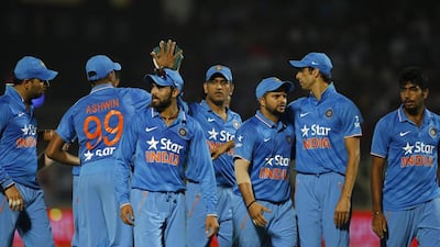 India's captain MS Dhoni, center, celebrates with teammates at the end of first innings of their third Twenty20 cricket match against Sri Lanka, in Vishakapatnam, India, Sunday, Feb. 14, 2016. (AP Photo/Aijaz Rahi)