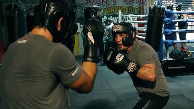 Yussef Hawatt, right, one of the contestants on Nomad Productions’s new reality-TV show Fighting Fit Dubai, trains at the Warehouse Gym in Dubai. Satish Kumar / The National