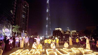 Participants gather at the Earth Hour Walk event at the Burj Plaza in Downtown Dubai last year. Jaime Puebla / The National