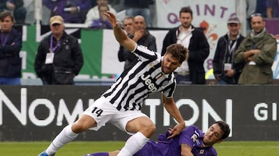 Juventus' Fernando Llorente, left, fights for the ball with Fiorentina's Gonzalo Rodriguez during their Serie A match at the Artemio Franchi stadium in Florence on October 20, 2013. Giampiero Sposito / Reuters