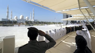A member of the Armed Forces salutes the flag.