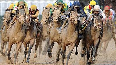Jockey Calvin Borel (white cap) guides Super Saver round the inside of the final turn of the Kentucky Derby.