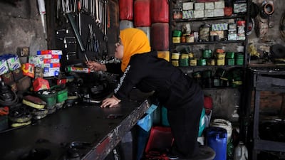 Ms Zanaty selects a tool at the garage. Reuters