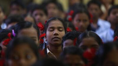 India schoolgirls in Mumbai offer prayers for victims killed in a Taliban attack on a military-run school in Peshawar. Rafiq Maqbool / AP Photo
