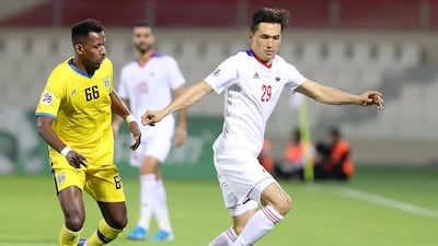 Otabek Shukurov of Sharjah takes of Mohammed Abousaban of Al Taawoun. Chris Whiteoak / The National