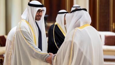 Sheikh Mohamed greets a member of the Kuwaiti delegation at Amiri Airport
