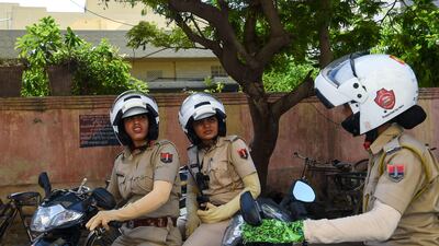 In this photo taken on June 14, 2017, members of a newly launched female police patrol unit drive through the old city in Jaipur. AFP / Chandan Khanna