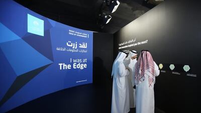 Emirati officials visit an exhibition during the opening day of the World Government Summit in Dubai. Kamran Jebreili / AP Photo