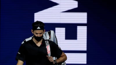 Austria's Dominic Thiem walks out wearing a face mask. Reuters