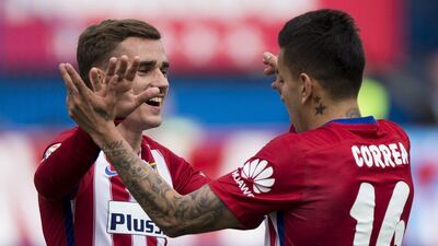 Antoine Griezmann, left, celebrates scoring their fourth goal with teammate Angel Martin Correa. Gonzalo Arroyo Moreno / Getty Images