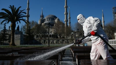 A municipality worker disinfects benches outside the Blue Mosque in Istanbul. Turkey's official measures against the coronavirus outbreak have been accompanied by a number of hoax remedies circulating among the public. AP Photo