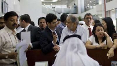 People attempt to apply for the new ID card at an Emirates Identity Authority Office in Dubai.