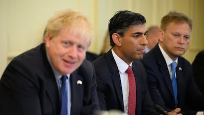 Rishi Sunak, centre, listening as his then boss Boris Johnson at 10 Downing Street. PA Wire