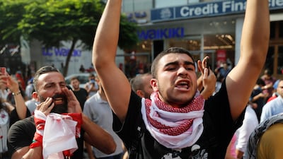 Anti-government protesters shout slogans near the spot where a Lebanese man killed himself on Beirut's Hamra Street on July 3, 2020. AP Photo