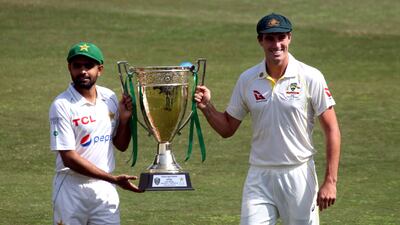 Pakistan's captain Babar Azam (L) and his Australian counterpart Pat Cummins (R) pose with the Test Series trophy prior to a practice session at the Rawalpindi Cricket Stadium in Rawalpindi, Pakistan, 02 March 2022. Pakistan and Australia cricket teams will play their first Test match on 04 March 2022. EPA / SOHAIL SHAHZAD