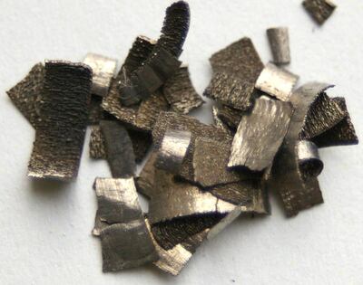 Dysprosium chips. Dysprosium is a rare earth element essential in making the permanent magnets used in wind turbines and electric vehicle batteries. Wikimedia Commons