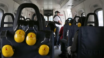 Workers sit aboard a Bristow Group helicopter as they arrive at Lagos airport after being flown off the Agbami floating production, storage and offloading vessel (FPSO), operated by Chevron Corp, in the Agbami deepwater oilfield in the Niger Delta, Nigeria. George Osodi / Bloomberg
