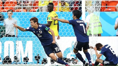 Yuya Osako, left, celebrates after scoring Japan's decisive second goal in the 2-1 win over Colombia. Elsa / Getty Images