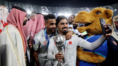 Bahrain players and staff celebrate with the Arabian Gulf Cup trophy after defeating Oman in the final at the Jaber Al Ahmad International Stadium in Kuwait City. Reuters