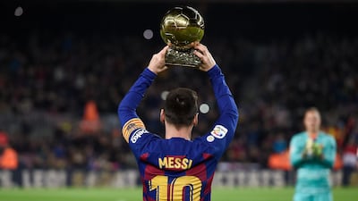 Messi poses with his sixth Ballon d'Or in December. AFP