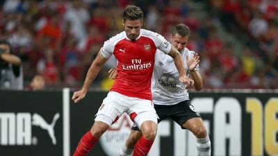 Olivier Giroud of Arsenal battles with Phil Jagielka of Everton during the Asia Trophy final on Saturday in Singapore. Stanley Chou / Getty Images