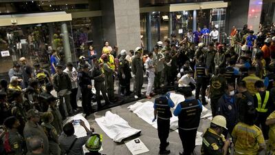 The bodies of victims lie outside the Siam Commercial Bank headquarters in Bangkok, Thailand, on March 14, 2016. They died after fire-suppression chemicals were accidentally released in the building on Sunday. EPA