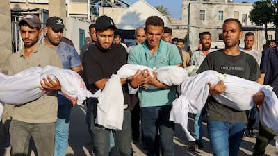 Men carry the bodies of children killed on Wednesday in an Israeli strike on Gaza city. AFP