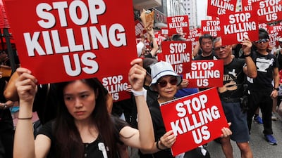 Protesters hold placards as they attend a demonstration demanding Hong Kong's leaders to step down and withdraw the extradition bill, in Hong Kong, China. Reuters