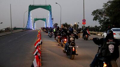 Motorcycles drive over a suspension bridge in the Green Zone in Baghdad. Reuters