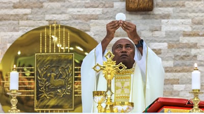 Reverend Father Peter Fernando during the Easter Sunday service at St Therese Church in Abu Dhabi. Victor Besa / The National