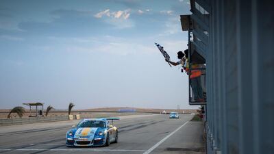 Jeffrey Schmidt, of Al Nabooda Racing takes the checkered flag during the Porsche GT3 Cup Challenge Middle East, Round 2 at Saudi Arabia’s Al Reem Circuit. Courtesy HK Strategies