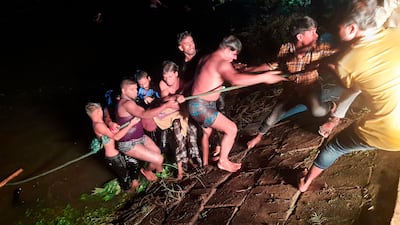 People engage in rescue work after a passenger boat carrying more than 100 people sank after a collision in a large pond in Brahmanbaria district, Bangladesh, Friday, Aug. 27, 2021. The sinking occurred in the Bijoynagar area in Brahmanbaria district in the evening, local police official Imranul Islam said by phone. Rescuers recovered at least 21 bodies by late Friday. (AP Photo)