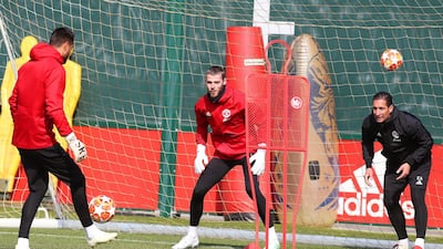 Manchester United goalkeeper David De Gea, centre, goes through his training drills. EPA