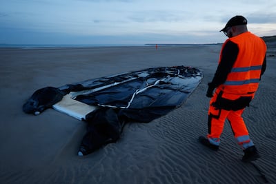 An inflatable boat punctured by police lies on the beach at Gravelines, northern France. AP