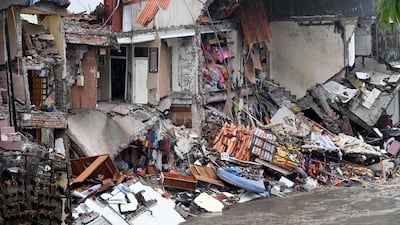 Damaged and collapsed houses. AFP