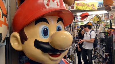 Customers check used videogame consoles and software at a videogame shop in Tokyo. Nintendo’s trailblazing Game Boy marks its 25th anniversary Monday with the portable device’s legacy living on in cutting-edge smartphone games and among legions of nostalgic fans. Yoshikazu Tsuno / AFP Photo