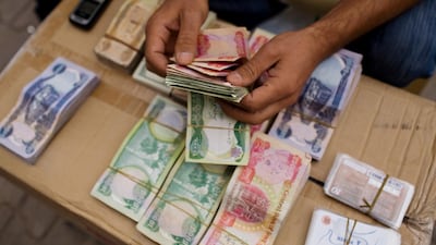 A phone card salesman trading in dinars in Erbil, Iraqi Kurdistan. Philip Cheung / The National