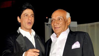 Indian Veteran Bollywood filmmaker, director, screenwriter and producer Yash Raj Chopra (R) celebrates his 81st birthday with actor Shah Rukh Khan (L) at a film promotion in Mumbai on September 27, 2012. AFP PHOTO/ STR