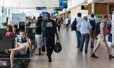 Passengers at Cape Town International Airport. Alamy