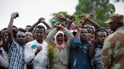 Residents of Bishoftu crossing their wrists above their heads as a symbol for the Oromo anti-government protest movement during the Oromo new year holiday Irreechaa in Bishoftu. Ethiopia declared a state of emergency on October 9, 2016 following months of violent anti-government protests. AFP / Zacharias ABUBEKER