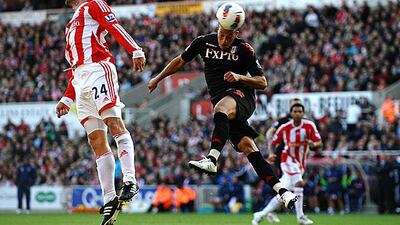 Rory Delap, the Stoke midfielder, completely misses the ball as Bobby Zamora, the Fulham striker, connects with a header on goal during Stoke's 2-0 win at the Britannia Stadium. Laurence Griffiths / Getty Images