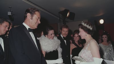 Queen Elizabeth meets actor Rex Harrison and his wife Rachel Roberts at the premiere of 'Dr Dolittle' in London. Getty
