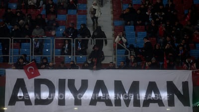 Fans hold a banner with name of the devastated city of Adiyaman before the Europa Conference League match. AP