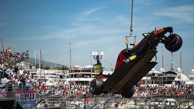 The car of Red Bull driver Max Verstappen of the Netherlands is lifted from the track by a crane after he crashed during the qualification at the Monaco racetrack in Monaco, Monaco, Saturday, May 28, 2016. The Formula one race will be held on Sunday. (AP Photo/Andrej Isakovic/Pool)