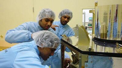 Three of the 16 Emirati engineers assigned to the DubaiSat-1 project work on the satellite in Daejeon, South Korea.
