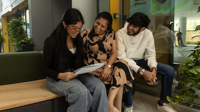 Jeni receives her results with her mother Kohilarani and her brother Christopher