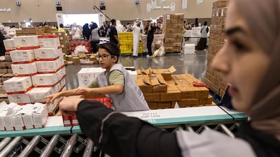 Volunteers pack 10 millions meals to support the people of Gaza, as Dubai Expo City. Antonie Robertson / The National