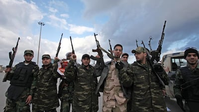 Libyan gunmen celebrate on the early morning of the second anniversary of the revolution that ousted Moammar Gadhafi, in Benghazi, Libya, Sunday, Feb, 17 2013. (AP Photo/Mohammad Hannon)